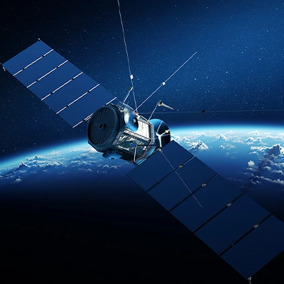 Satellite orbiting above Earth with solar panels extended, set against the backdrop of space and the planet’s curved horizon.